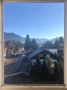 a view from a window of a street with a car at Herzensnest mit Grüntenblick in Immenstadt in Immenstadt im Allgäu