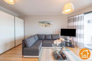 Televízia a/alebo spoločenská miestnosť v ubytovaní Apartamenty Horyzont - visitopl