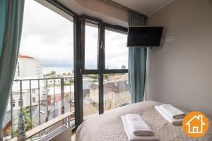 Posteľ alebo postele v izbe v ubytovaní Apartamenty Horyzont - visitopl