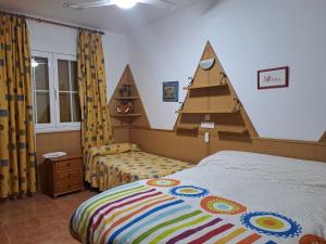 a bedroom with two beds and a pirate tent at Alojamiento Árdales in Frailes