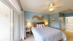 a bedroom with a bed and a ceiling fan at Lake Views, 2BR, 2BA, Lakeside Villa in Pawleys Island