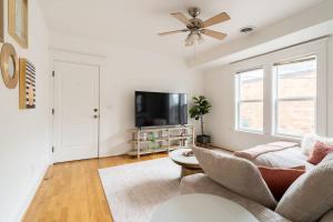 a living room with a couch and a flat screen tv at The Bohemian Spirit - Live Music, Eateries & Bars in Portland +28 photos