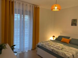 a bedroom with a bed and a large window at Fantasticasa in Nettuno