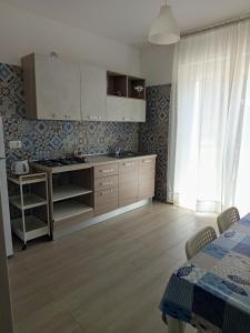a kitchen with a sink and a stove at Dimora Basso in Mattinata