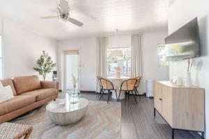 a living room with a couch and a table at Bliss stylish apartment with pool, by beach in Riviera Beach