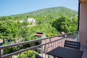 a balcony with a table and a view of a mountain at Apartments Adriana in Klenovica