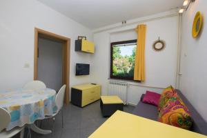 a living room with a table and a couch at Apartments Adriana in Klenovica