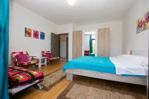 a bedroom with a bed and a table and chairs at Apartments Adriana in Klenovica