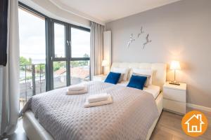 Posteľ alebo postele v izbe v ubytovaní Apartamenty Horyzont - visitopl