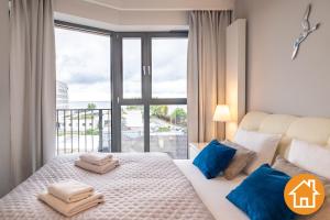 Posteľ alebo postele v izbe v ubytovaní Apartamenty Horyzont - visitopl