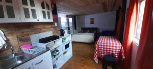 a kitchen with a table and a bed in a room at Ema Juan in Navidad