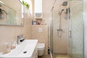 a bathroom with a shower and a sink and a toilet at APARTMENT LEA BAYVIEW in Dubrovnik +45 photos