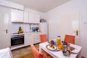 a kitchen with a table with food on it at APARTMENT LEA BAYVIEW in Dubrovnik
