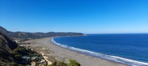 a view of a beach with the ocean at Ema Juan in Navidad