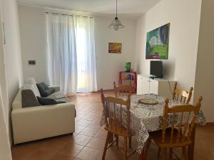 a living room with a couch and a table at Favignana Holidays 2 in Favignana