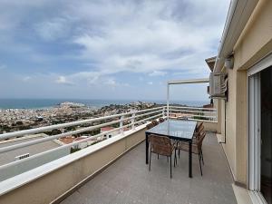 a balcony with a table and chairs on a balcony at El Mirador de Peñiscola in Peñíscola