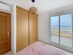 a room with a sliding door and a window at El Mirador de Peñiscola in Peñíscola +18 photos