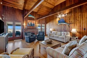 a living room with wooden walls and wooden floors at 1180 S Fletcher Ave in Fernandina Beach +39 photos