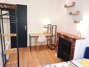 a living room with a table and a fireplace at Sadi Carnot - 2A in Millau
