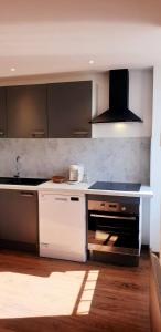a kitchen with a sink and a stove top oven at 3 Liberte- 3rd in Saint-Affrique