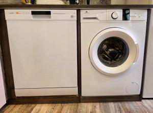 a white washing machine sitting in a room at Mitrons - 1B in Saint-Affrique