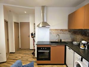 a kitchen with a sink and a stove top oven at Mitrons - 2B in Saint-Affrique