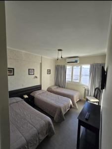 En eller flere senge i et værelse på Calfucura Apart Hotel