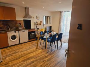 a kitchen and dining room with a table and chairs at Mitrons - 3A in Saint-Affrique