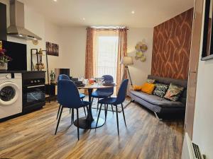 a living room with a table and chairs and a couch at Mitrons - 2A in Saint-Affrique