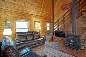 a living room with a couch and a stove at Large Wraparound Deck, Foosball Table, Close to Beacon Landing Marina in Grand Lake