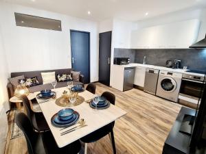 a kitchen and living room with a table and chairs at Rep - 1B in Millau