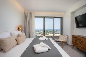 Ένα ή περισσότερα κρεβάτια σε δωμάτιο στο Athoros Luxury Villas