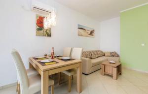 a living room with a table and a couch at MERTIK Apartment in Omišalj