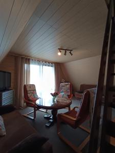 a living room with a table and chairs and a window at Domek u Marty in Solina