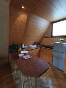 a small kitchen with a table and a refrigerator at Domek u Marty in Solina