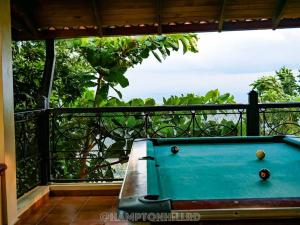 a blue pool table in front of a balcony at Hampton Hill La Loma - Escapada Natural, Santiago RD 