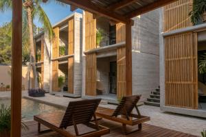 a house with two chairs and a pool at Jiloo Beautiful Oasis in Punta Zicatela 3 in Brisas de Zicatela