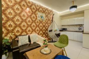 a living room with a couch and a table at City view stay by Royal Rooms in Noida
