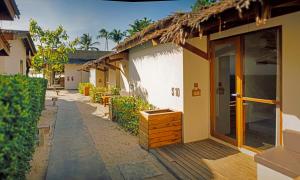 a building with a walkway next to a street at Escape Beach Resort - SHA Extra Plus Certified in Mae Nam