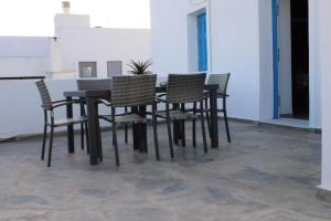 a black table and chairs with a potted plant on it at Family- House in Chora, kythnos in Kithnos