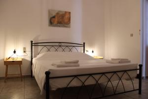 a bedroom with a bed with towels on it at Family- House in Chora, kythnos in Kithnos