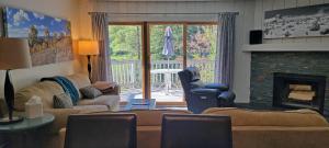 a living room with a couch and a fireplace at On Gore Creek, Pet Friendly, Steps from Free Bus Stop & Great Value in Vail