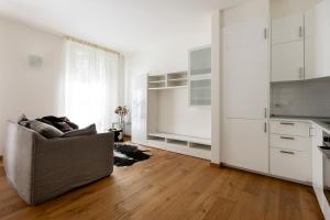 a living room with a couch and a kitchen at La Residenza sul Mera in Chiavenna