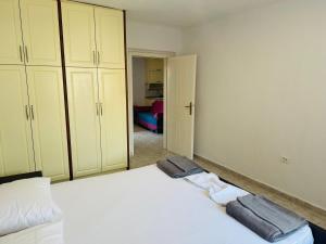 a bedroom with a bed with towels on it at RIA apartment in Himare