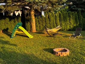 a playground with a hammock and a hamminet and a hammockablish at Chata Domaša - Monika in Holčíkovce