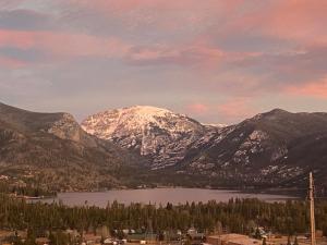 a view of a snow covered mountain with a lake at Lula in Grand Lake