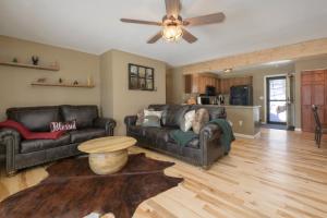 a living room with two leather couches and a table at Lula in Grand Lake