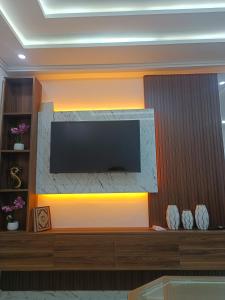 a living room with a television on a wall at Haute qualité in Al Hoceïma +9 photos