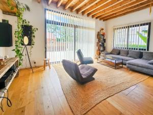 a living room with a couch and a chair at Loft Campagnard, Jardin, Terrasse in Saint-Augustin