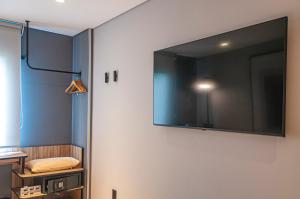 a large flat screen tv hanging on a wall at Ibis Monterrey Aeropuerto in Monterrey +30 photos